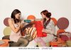 stock-photo-young-girls-exchanging-gifts-on-a-colorful-sofa-134467142.jpg