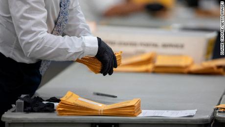 DETROIT, MI - NOVEMBER 04: A worker with the Detroit Department of Elections helps sort through absentee ballots at the Central Counting Board in the TCF Center on November 4, 2020 in Detroit, Michigan. President Trump narrowly won Michigan in 2016, and both he and Joe Biden campaigned heavily in the battleground state in 2020. (Photo by Elaine Cromie/Getty Images)