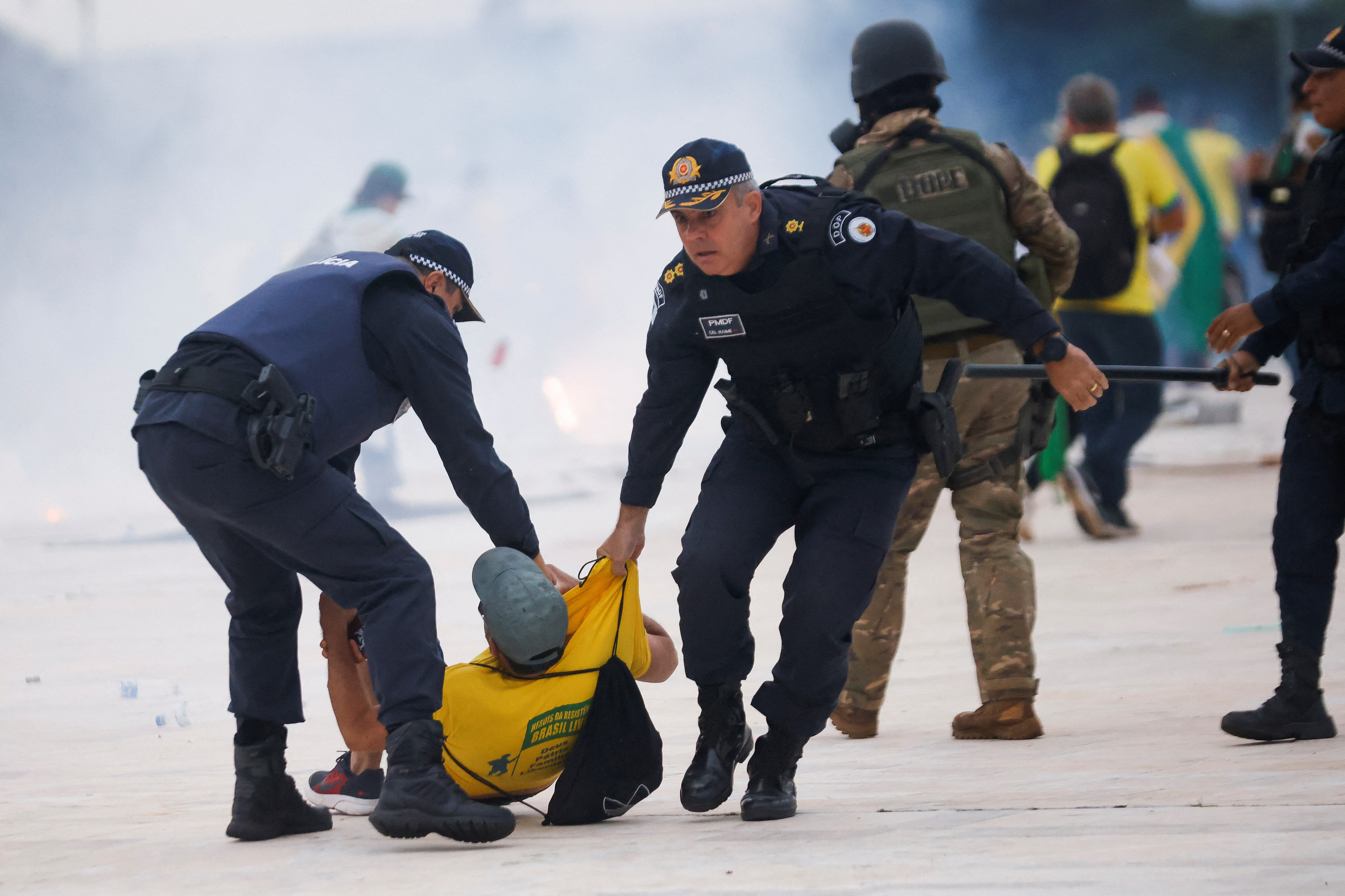 Security forces detain a supporter of Brazil's former President Jair Bolsonaro during a demonstration against President Luiz Inácio Lula da Silva, outside Brazil’s National Congress in Brasília, Brazil on Sunday.